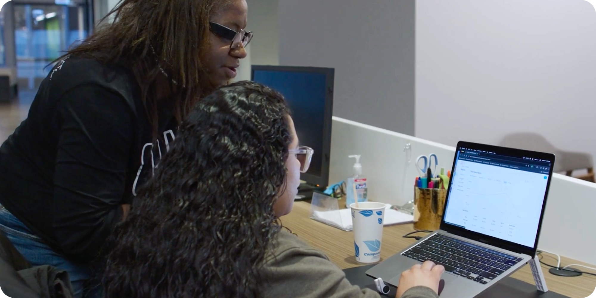 Workplace team analyzing office pantry budget in platform on laptop Workplace team analyzing office pantry budget in platform on laptop